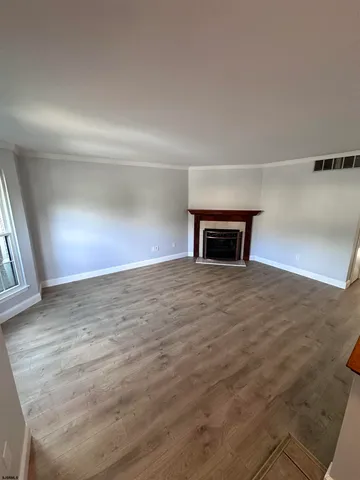 a view of empty room with window and fireplace