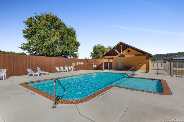 a view of a swimming pool with a lounge chair