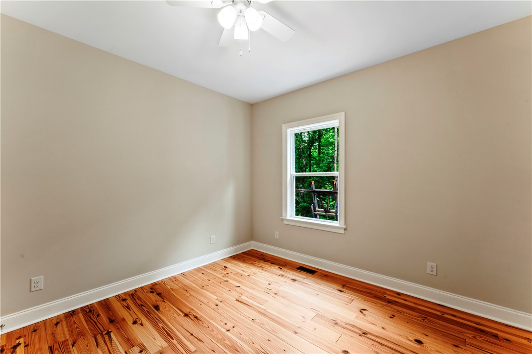 110 Gabriel Way Pickens, SC 29671 - Photo 29 of 48 Bright hardwood floors and treetop views define this tranquil bedroom.