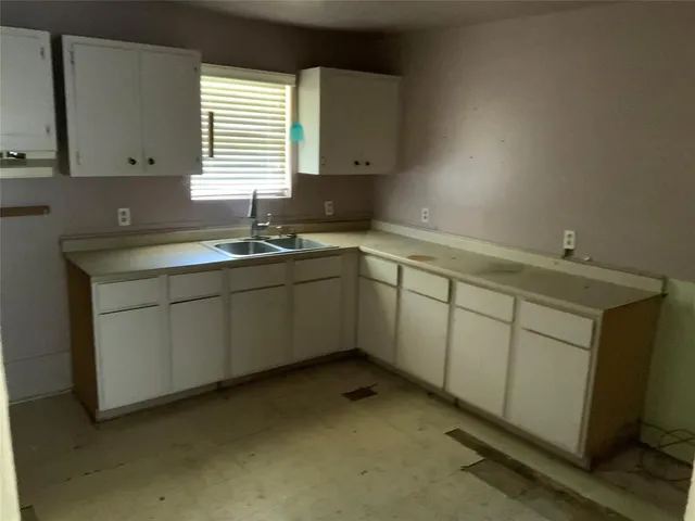 a kitchen with sink cabinets and window