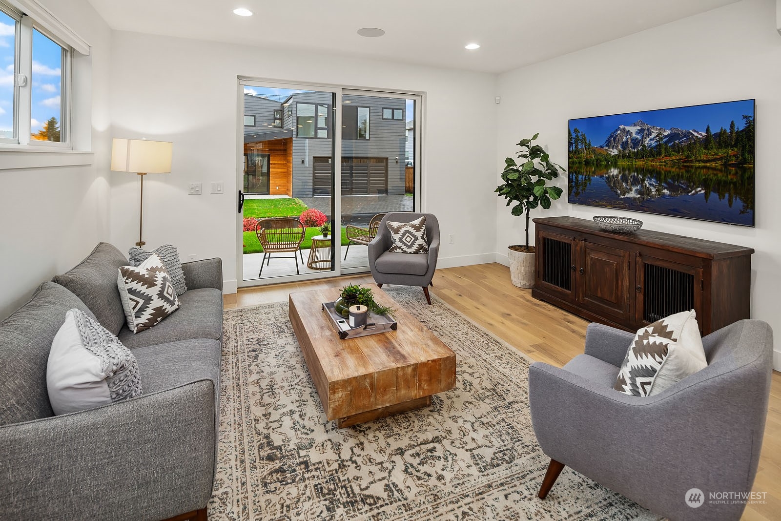 910 North 31st Street Renton, WA 98056 - Photo 13 of 32 a living room with furniture a flat screen tv and a fireplace