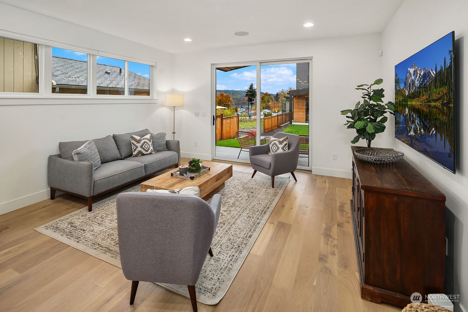 910 North 31st Street Renton, WA 98056 - Photo 14 of 32 a living room with furniture a flat screen tv and a potted plant