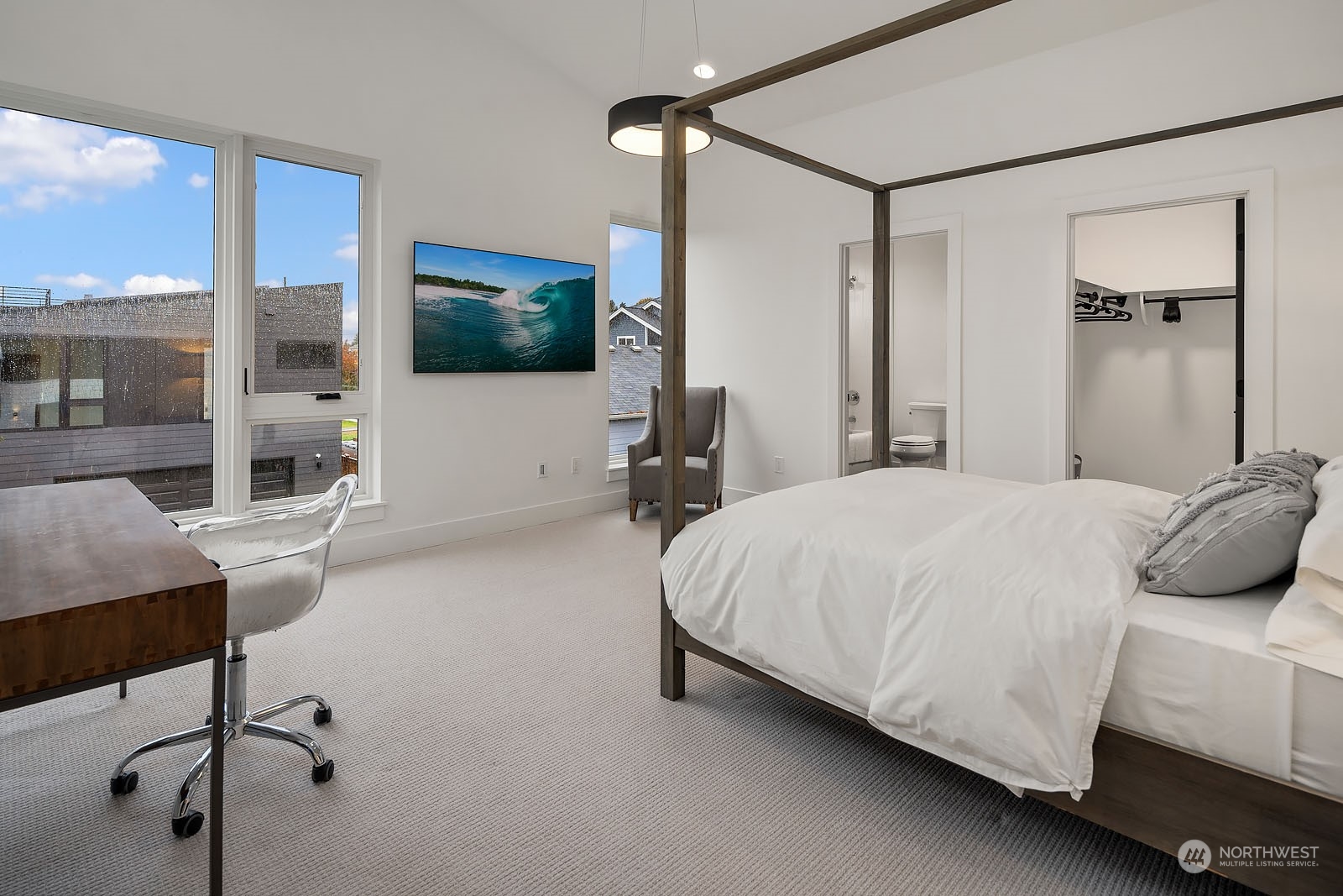 910 North 31st Street Renton, WA 98056 - Photo 24 of 32 a bedroom with a large bed and a flat screen tv