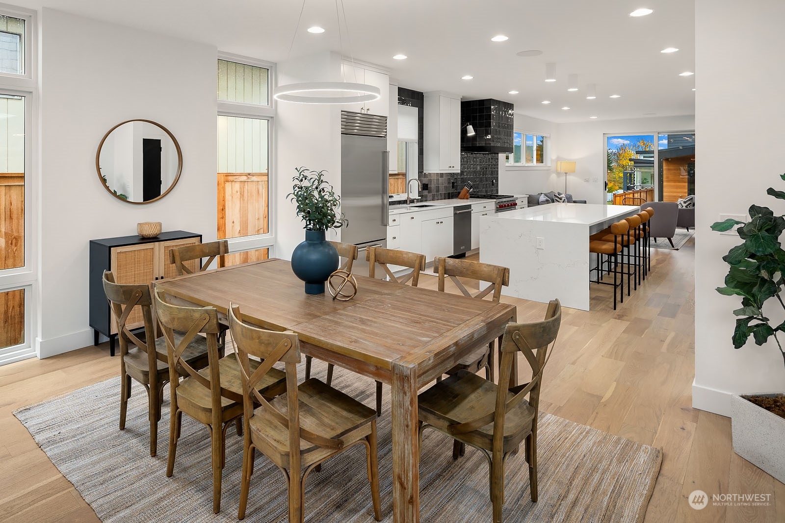 910 North 31st Street Renton, WA 98056 - Photo 8 of 32 a dining room with furniture a mirror and wooden floor