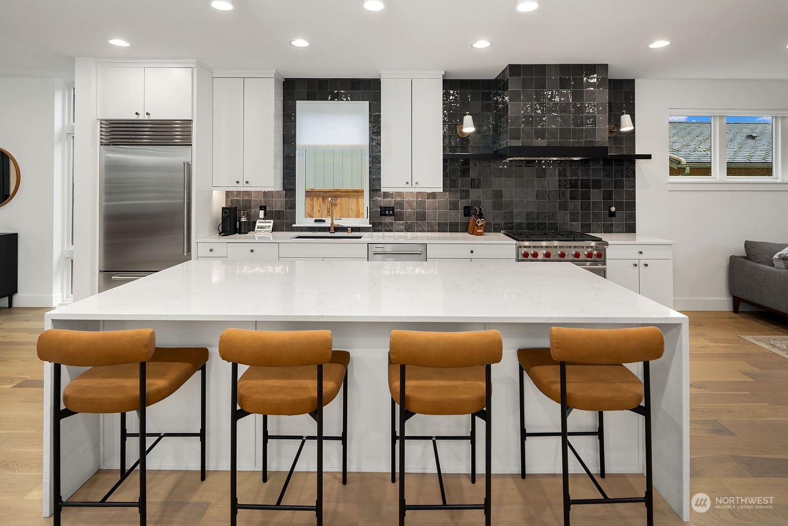 910 North 31st Street Renton, WA 98056 - Photo 9 of 32 a kitchen with stainless steel appliances granite countertop a table chairs sink and cabinets