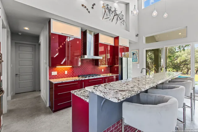 a bedroom with a bed couch and large windows