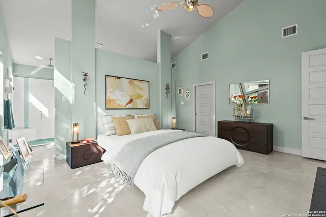 a living room with furniture a bookshelf and a window