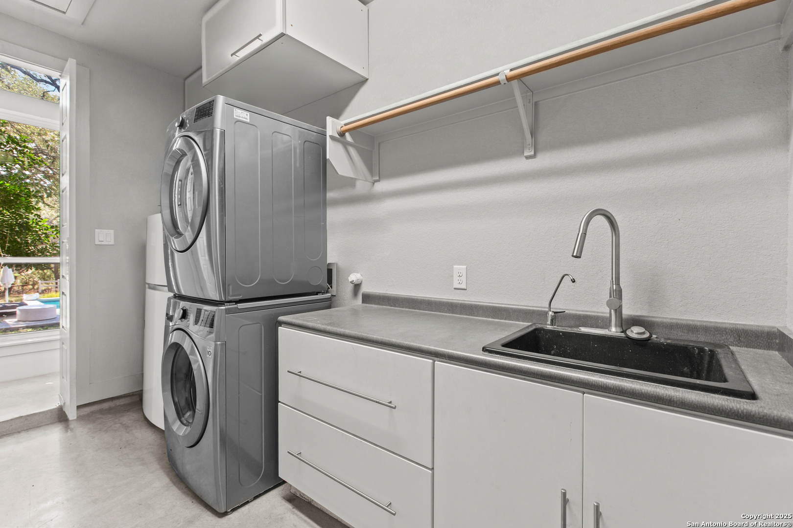 1280 Stoney Ridge Road Bulverde, TX 78163 - Photo 22 of 25 a utility room with sink dryer and washer