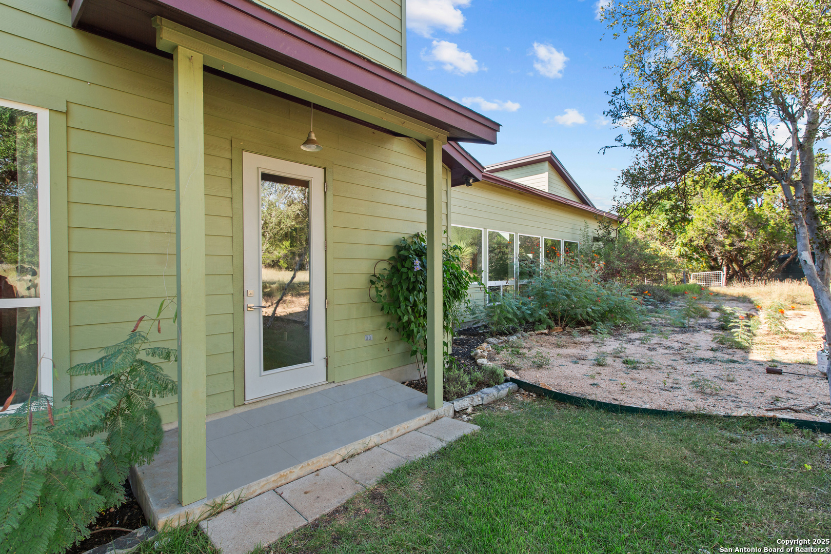 1280 Stoney Ridge Road Bulverde, TX 78163 - Photo 24 of 25 a view of a backyard with plants and large tree