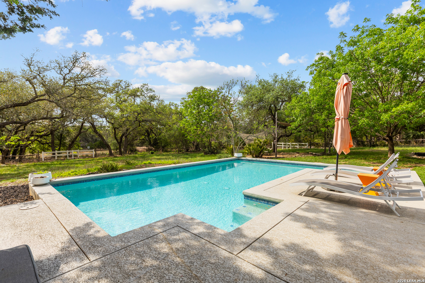 1280 Stoney Ridge Road Bulverde, TX 78163 - Photo 27 of 43 a view of a swimming pool with lounge chairs