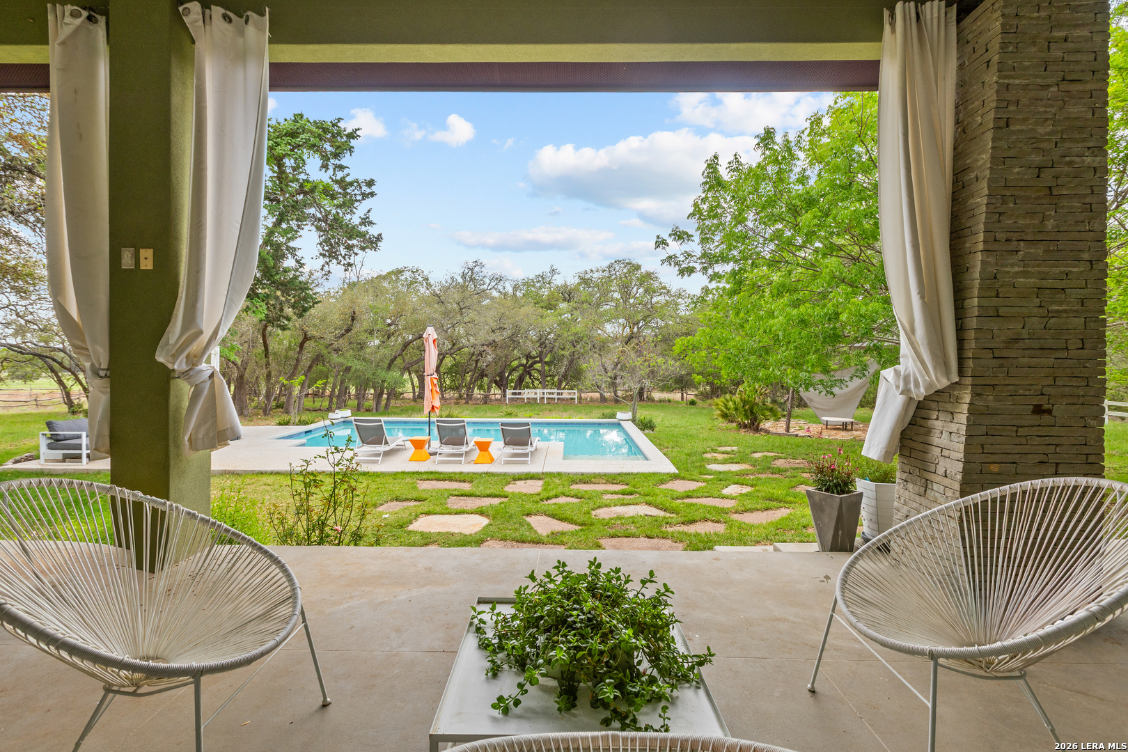 1280 Stoney Ridge Road Bulverde, TX 78163 - Photo 28 of 43 a view of a swimming pool with a patio