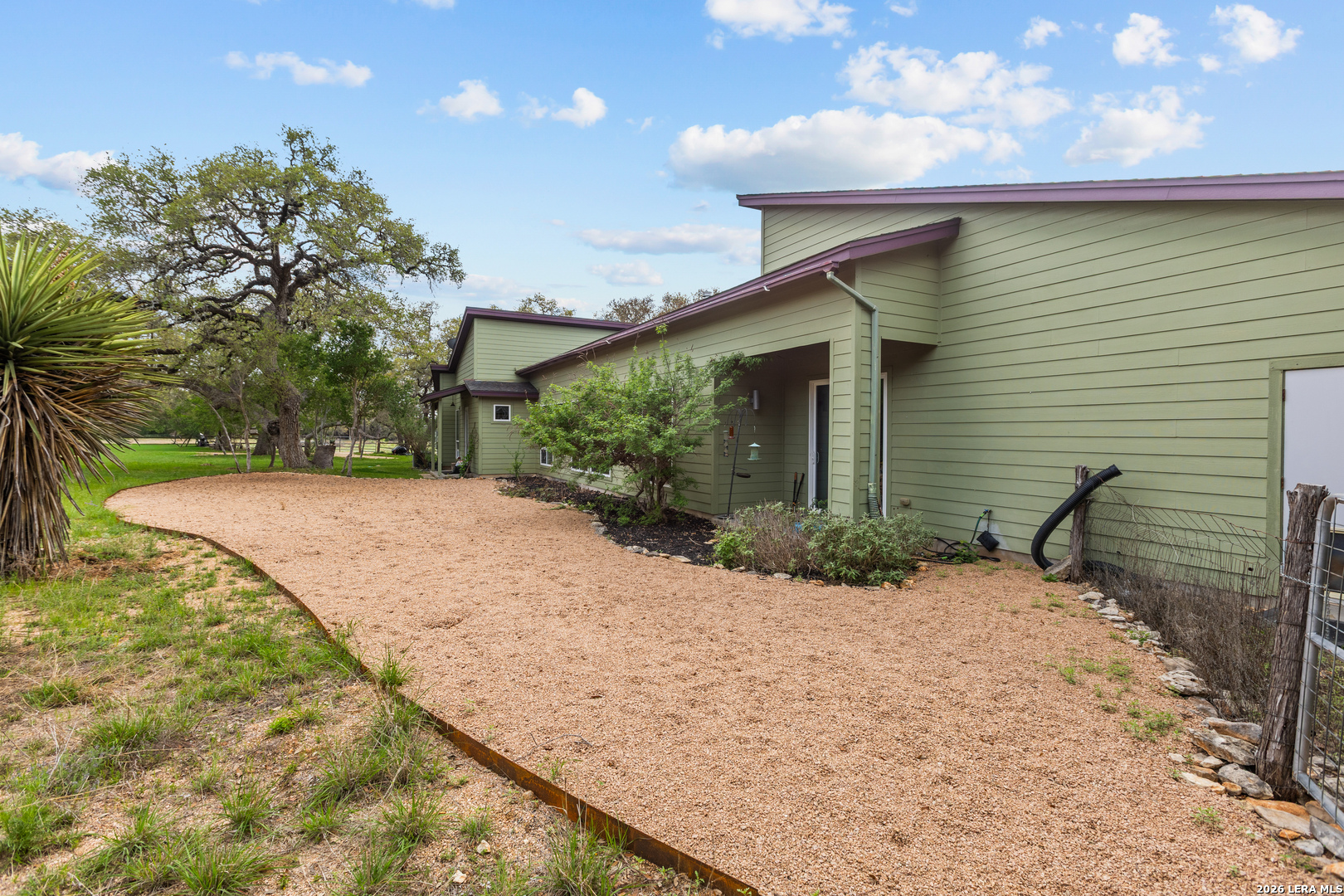1280 Stoney Ridge Road Bulverde, TX 78163 - Photo 29 of 43 a backyard of a house with large trees and outdoor space
