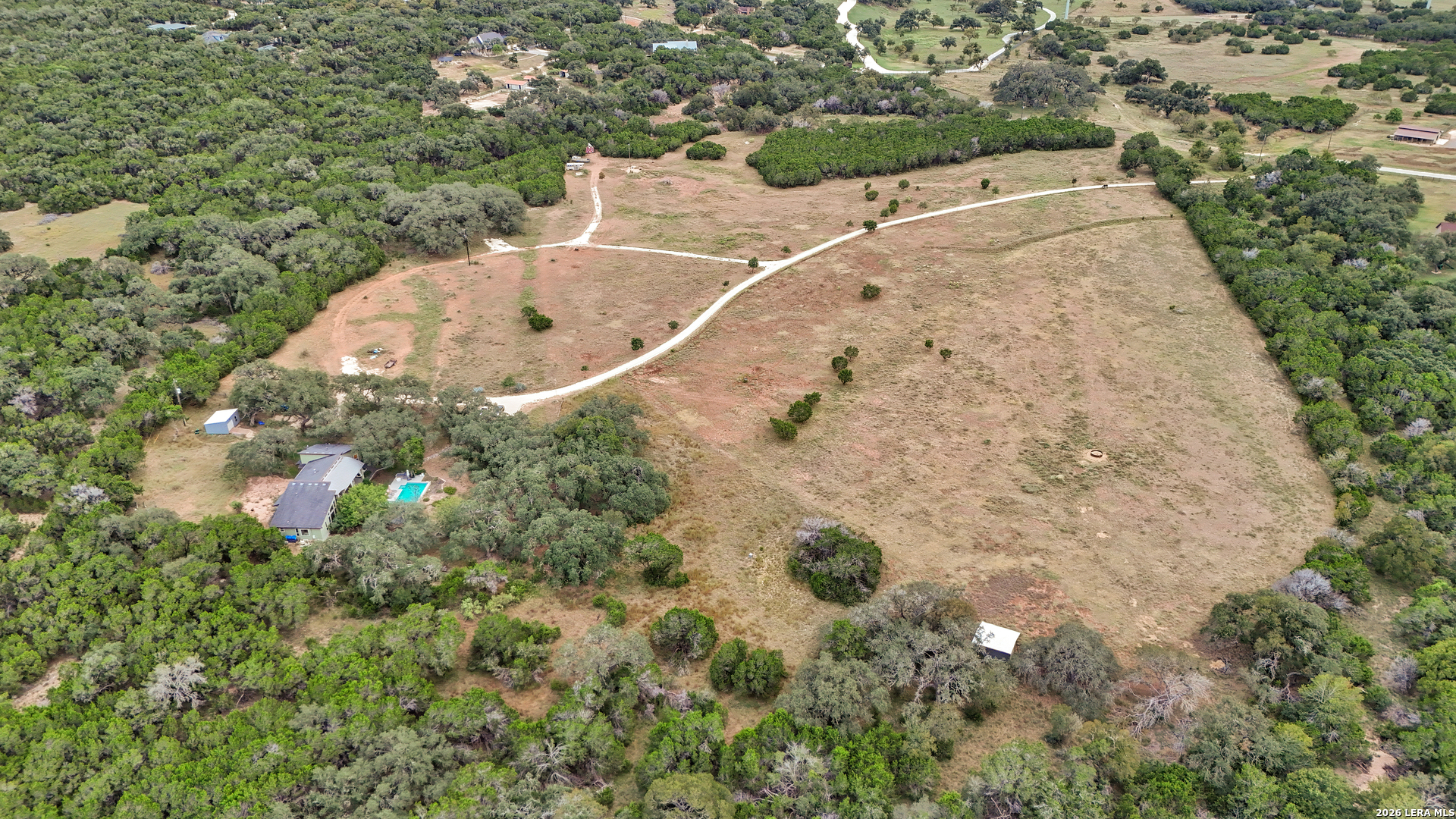 1280 Stoney Ridge Road Bulverde, TX 78163 - Photo 33 of 43 an aerial view of a house with a yard and large trees