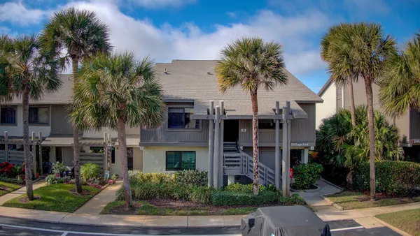 a front view of multiple houses with yard