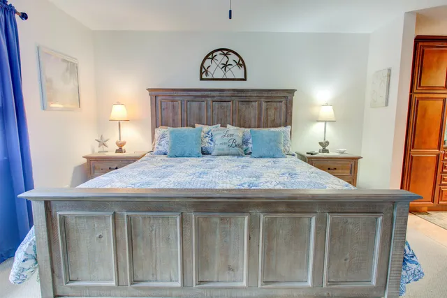 a bedroom with a balcony a bed and a mirror