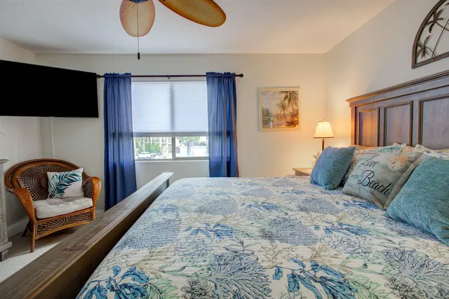 a bedroom with a large bed and a window