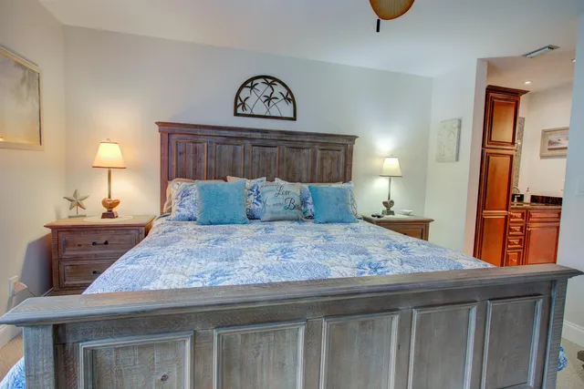 a bedroom with a bed and chandelier