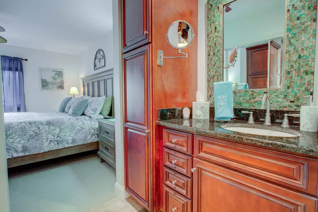 a bedroom with a bed and a potted plant