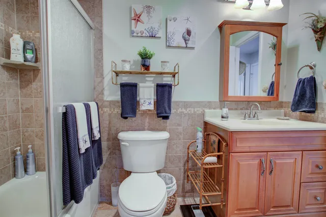 a bathroom with a toilet a sink and a mirror