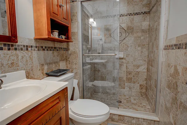 a bathroom with a sink a toilet and shower