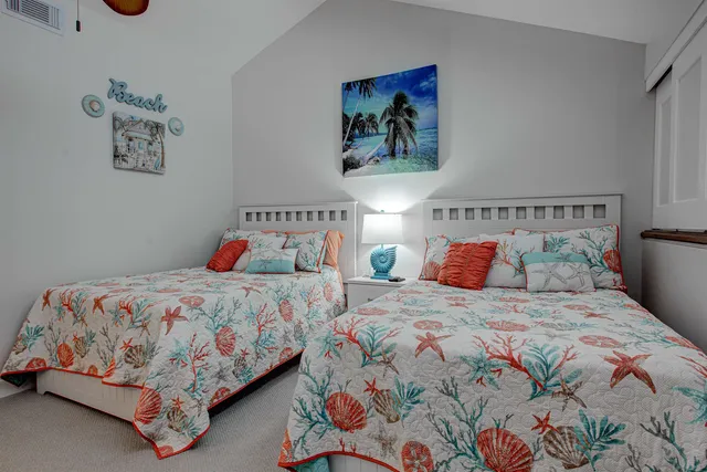 a bedroom with a bed and painting on the wall