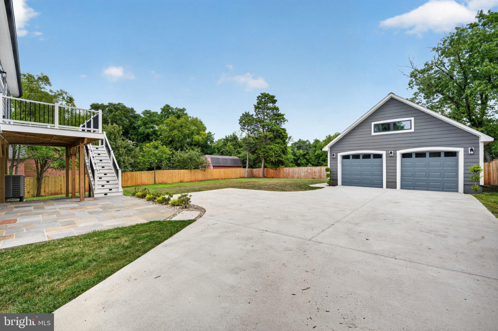 Spacious driveway with serene backdrop.