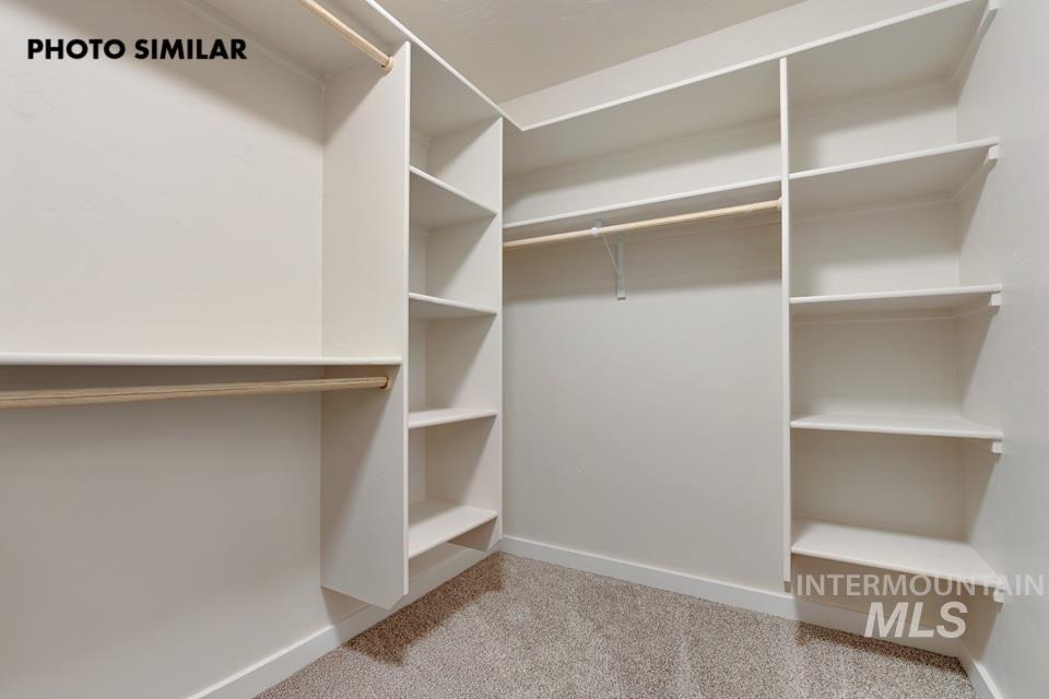 1645 Haystack Emmett, ID 83617 - Photo 20 of 33 Walk-in closet featuring built-in shelving, white walls, light-colored carpet, and hanging rods