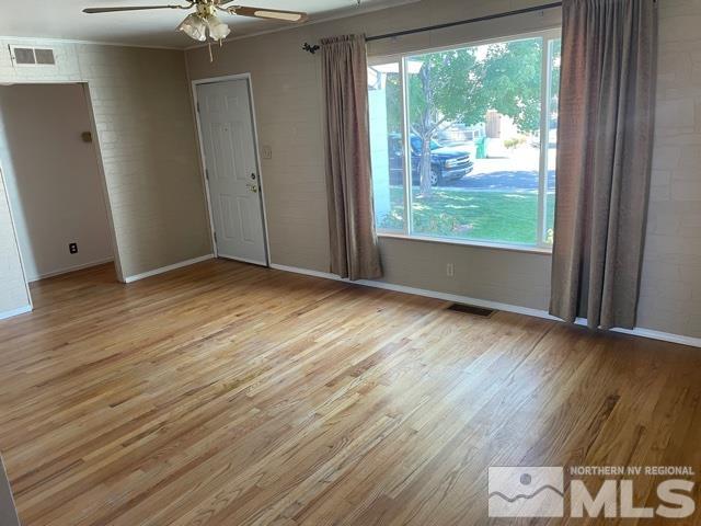 1650 Auburn Way Reno, NV 89502 - Photo 2 of 21 an empty room with wooden floor and windows