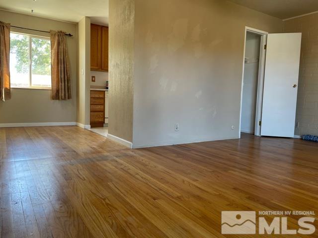 1650 Auburn Way Reno, NV 89502 - Photo 5 of 21 an empty room with wooden floor and windows
