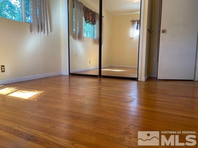 1650 Auburn Way Reno, NV 89502 - Photo 9 of 21 an empty room with wooden floor and windows