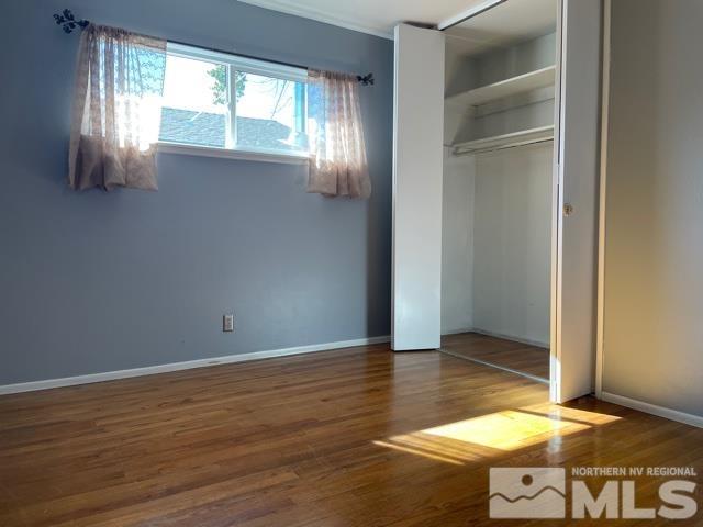 1650 Auburn Way Reno, NV 89502 - Photo 10 of 21 a view of an empty room with wooden floor and a window