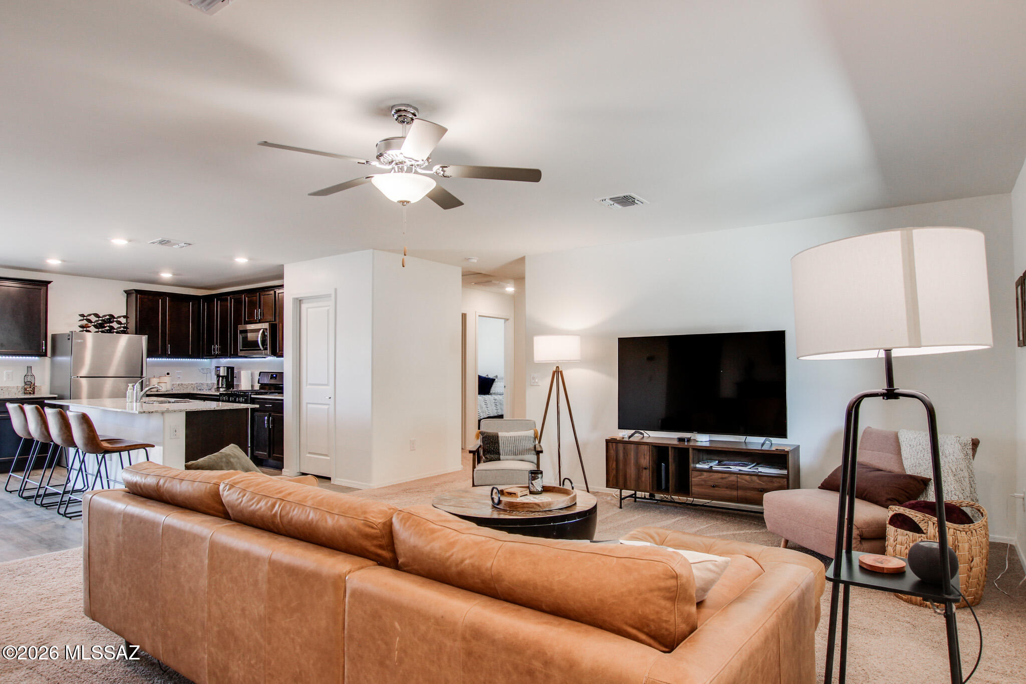 7056 South Draper Road Tucson, AZ 85757 - Photo 3 of 22 a living room with furniture and a flat screen tv