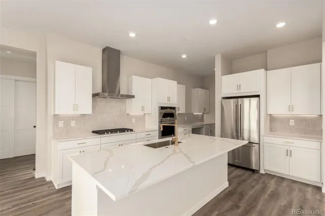 a kitchen with stainless steel appliances a refrigerator sink and microwave