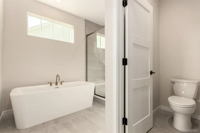a white toilet sitting next to a bathroom sink