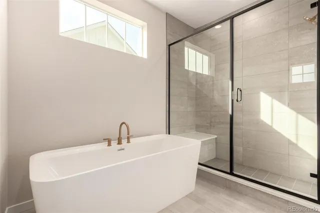 a white bath tub sitting next to a white sink