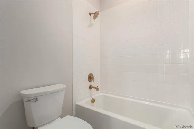 a bathroom with a toilet and a bathtub