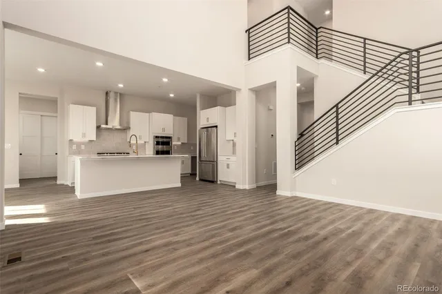 a view of kitchen stove refrigerator and wooden floor