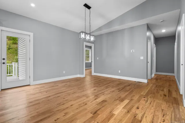 a view of a livingroom with a chandelier fan and a window