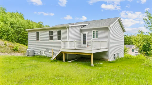 a backyard of a house with table and chairs