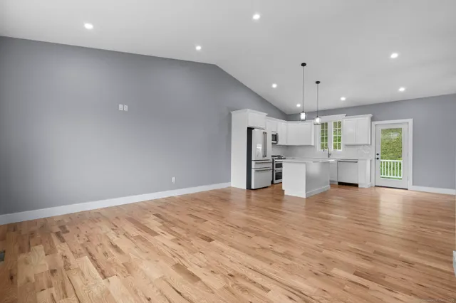 a view of kitchen and hall with wooden floor
