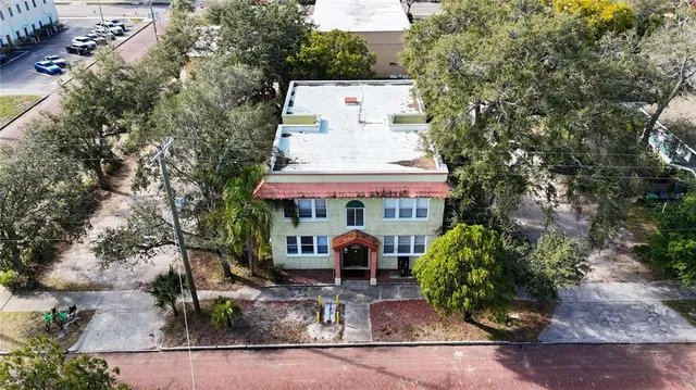 an aerial view of a house with a yard and sitting area