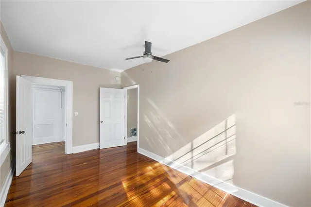 a view of a room with wooden floor and white walls