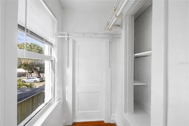 a view of an entryway with wooden floor and door