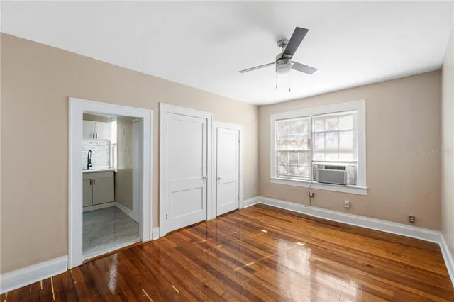 a view of a room with a window and a ceiling fan