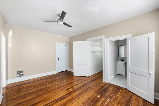 a view of empty room with wooden floor