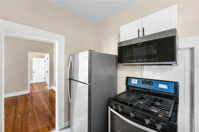 a kitchen with a stove and a microwave