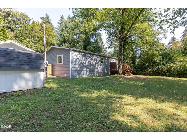 a view of a wooden house with a yard