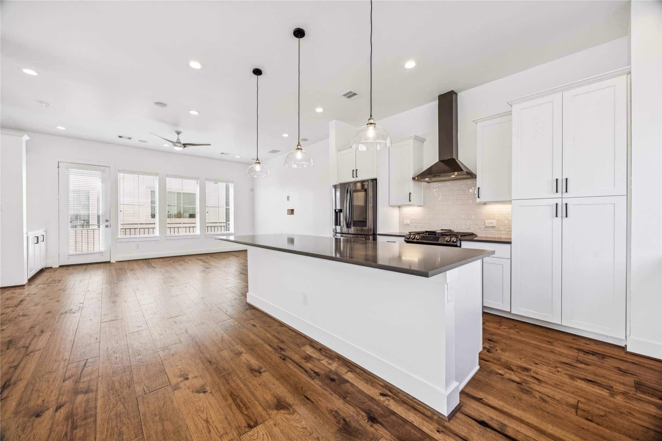 1812 West Webster Street Houston, TX 77019 - Photo 12 of 23 a kitchen with stainless steel appliances granite countertop a sink a stove a refrigerator and a wooden floor