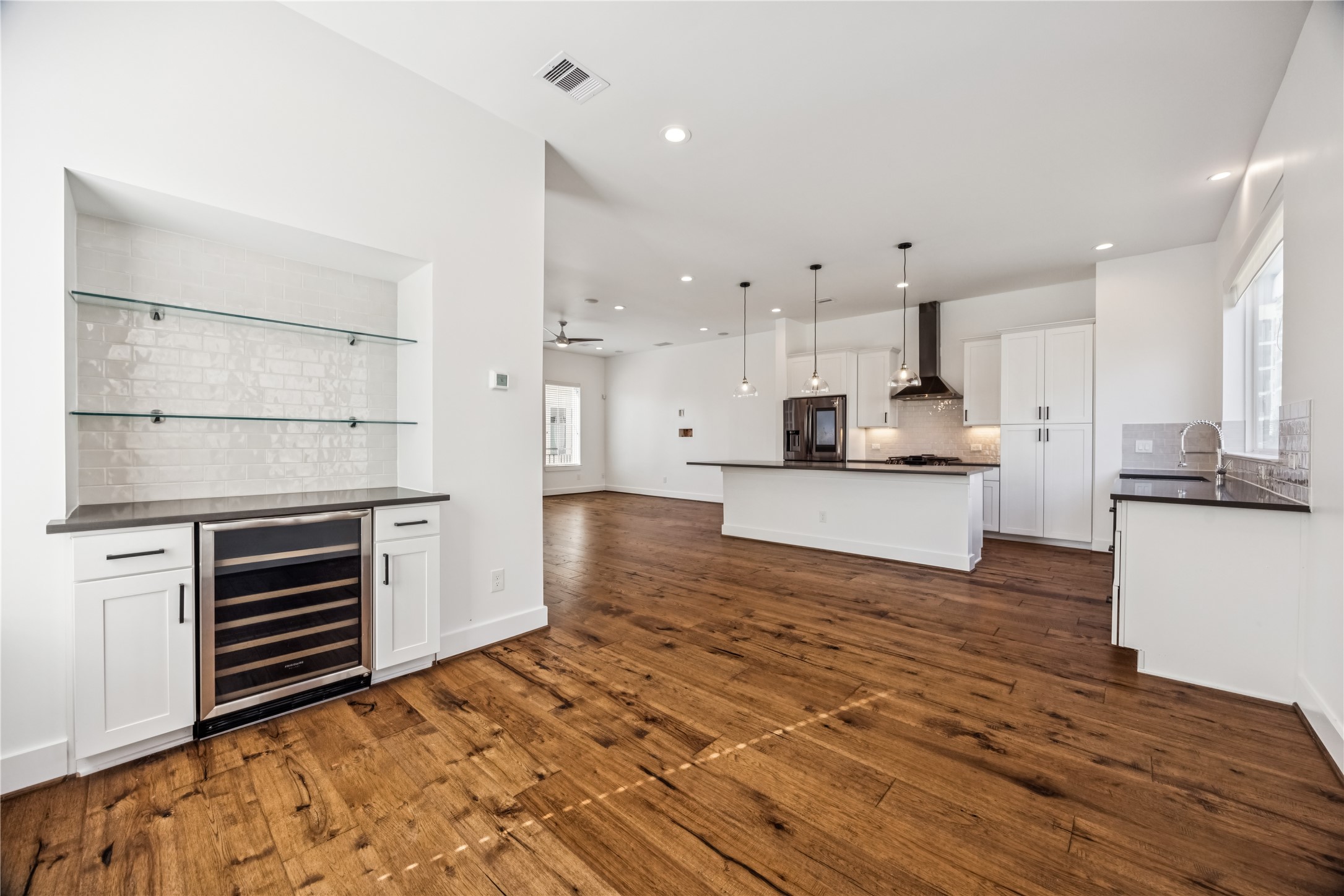 1812 West Webster Street Houston, TX 77019 - Photo 13 of 23 a kitchen with stainless steel appliances kitchen island granite countertop a stove and a refrigerator