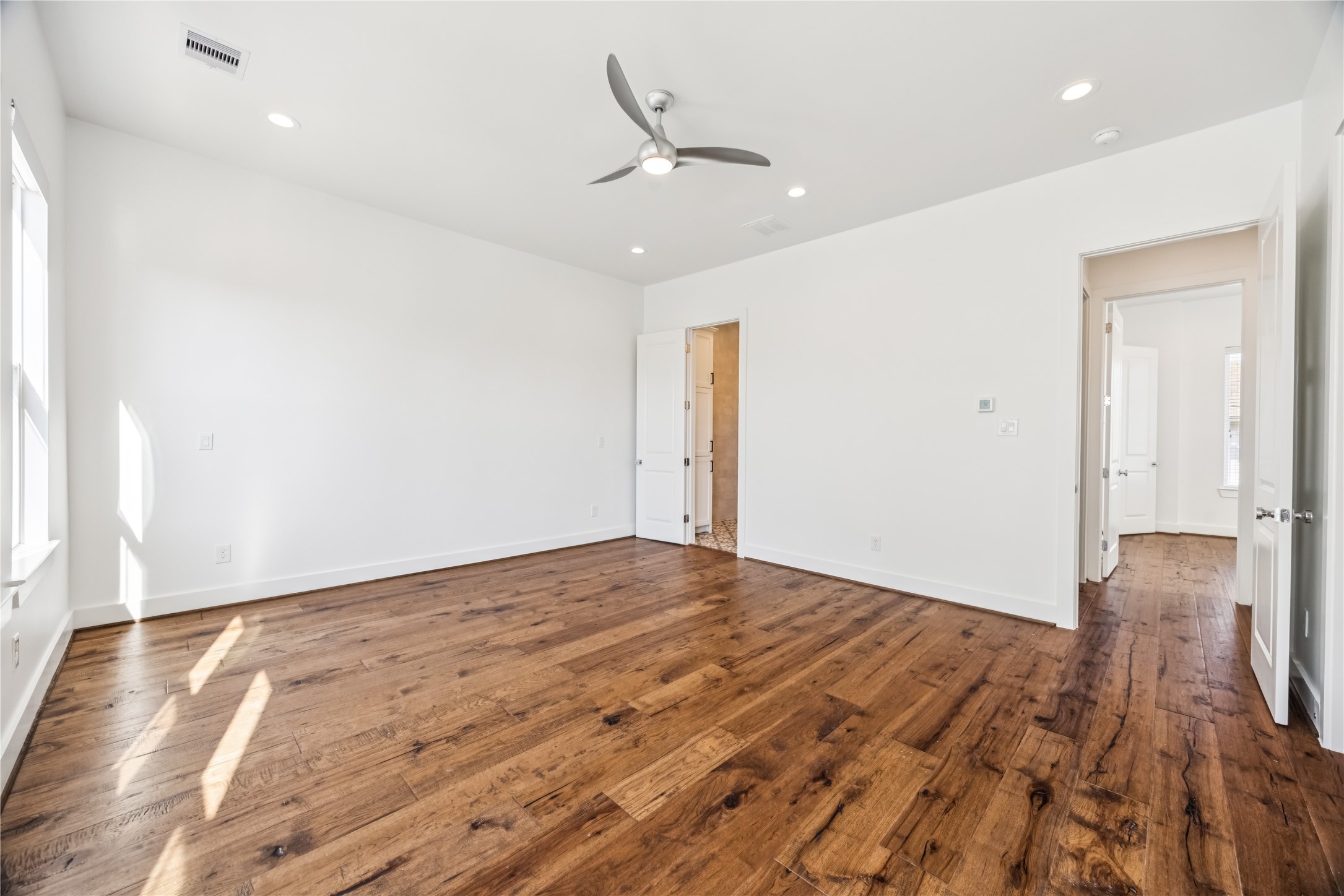 1812 West Webster Street Houston, TX 77019 - Photo 16 of 23 an empty room with wooden floor and a ceiling fan